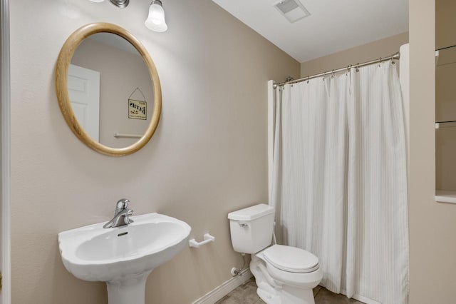bathroom featuring a shower with curtain, visible vents, a sink, baseboards, and toilet