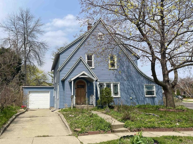 227 1st St, Baraboo, WI 53913 - view of front of property featuring a garage, a chimney, and driveway