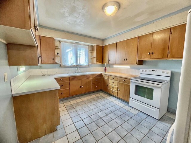 227 1st St, Baraboo, WI 53913 - kitchen with open shelves, a sink, light countertops, light tile patterned floors, and white electric range oven