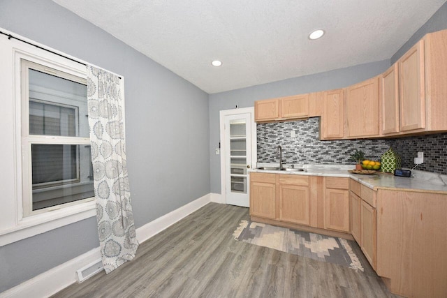 3613 N 19th St, Milwaukee, WI 53206 - kitchen with a sink, backsplash, and light brown cabinetry