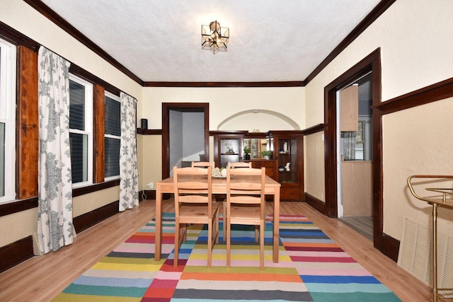 3613 N 19th St, Milwaukee, WI 53206 - dining room with a textured ceiling, visible vents, ornamental molding, and wood finished floors