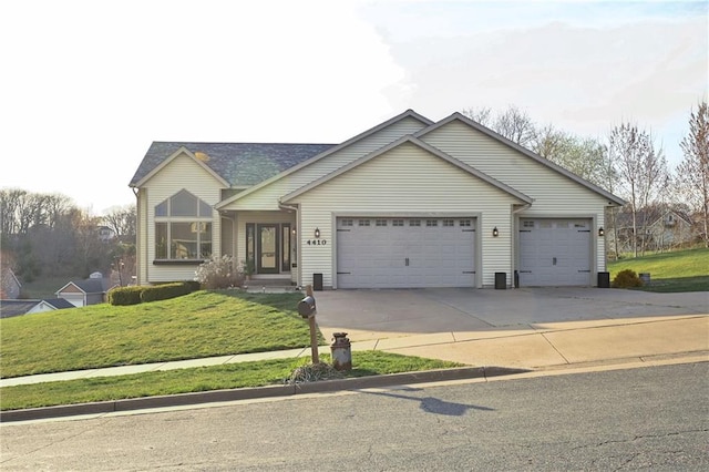 4410 Echo Valley Dr, Eau Claire, WI 54701 - view of front facade with a garage, driveway, and a front yard