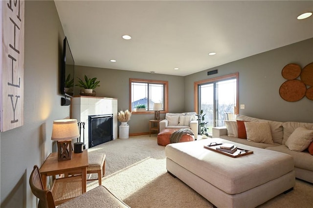 4410 Echo Valley Dr, Eau Claire, WI 54701 - living room featuring recessed lighting, baseboards, a glass covered fireplace, and light colored carpet