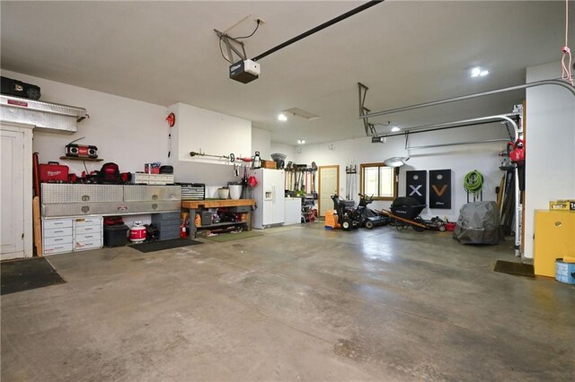 4410 Echo Valley Dr, Eau Claire, WI 54701 - garage with a garage door opener and white fridge with ice dispenser