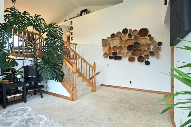 4410 Echo Valley Dr, Eau Claire, WI 54701 - stairway with carpet floors, a barn door, baseboards, and vaulted ceiling