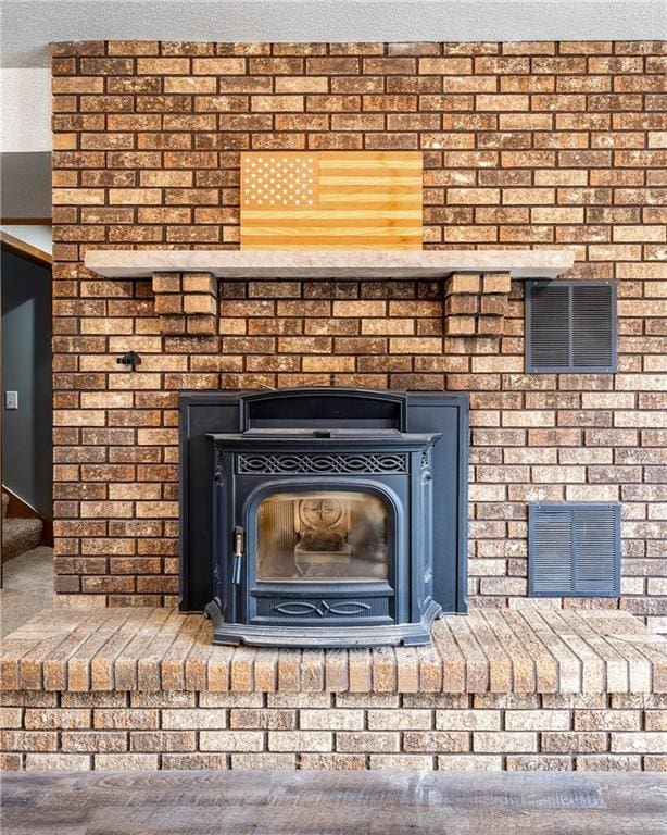 3434 Hester St, Eau Claire, WI 54701 - room details featuring visible vents, carpet floors, and a fireplace