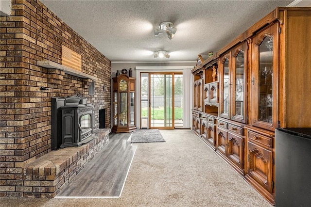 3434 Hester St, Eau Claire, WI 54701 - unfurnished living room with ornamental molding, brick wall, a fireplace, a textured ceiling, and light wood finished floors