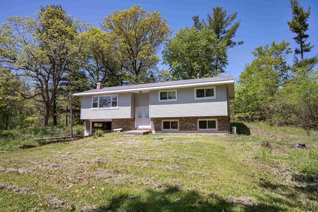 1680 Cree Dr, Arkdale, WI 54613 - raised ranch with brick siding, a chimney, and a front yard