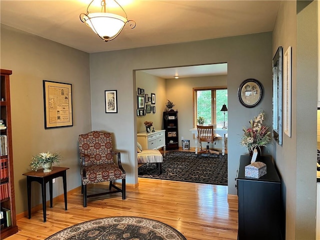 sitting room featuring light wood-style floors and baseboards