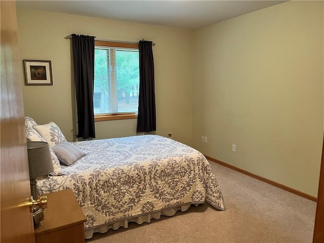 carpeted bedroom with baseboards