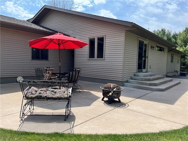 back of house with a patio, outdoor dining area, entry steps, and an outdoor fire pit