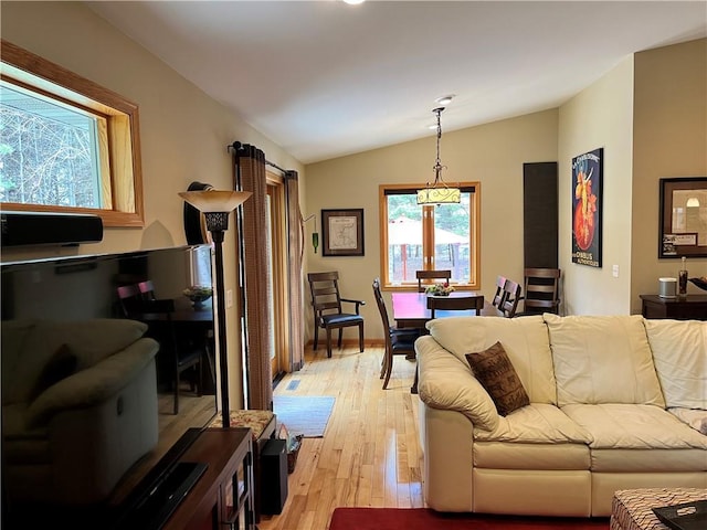 living room with light wood finished floors and lofted ceiling