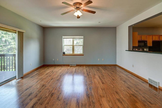 555 Kelvington Dr Unit 4, Sun Prairie, WI 53590 - unfurnished living room featuring plenty of natural light, a ceiling fan, wood finished floors, and baseboards
