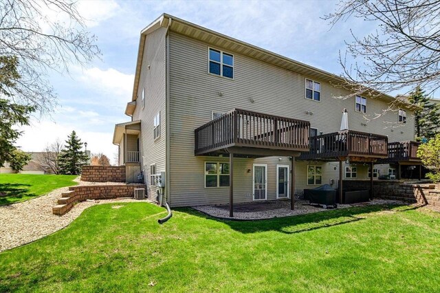 555 Kelvington Dr Unit 4, Sun Prairie, WI 53590 - back of house featuring a lawn and a wooden deck