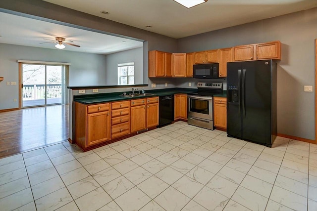 555 Kelvington Dr Unit 4, Sun Prairie, WI 53590 - kitchen featuring black appliances, a sink, dark countertops, ceiling fan, and a peninsula