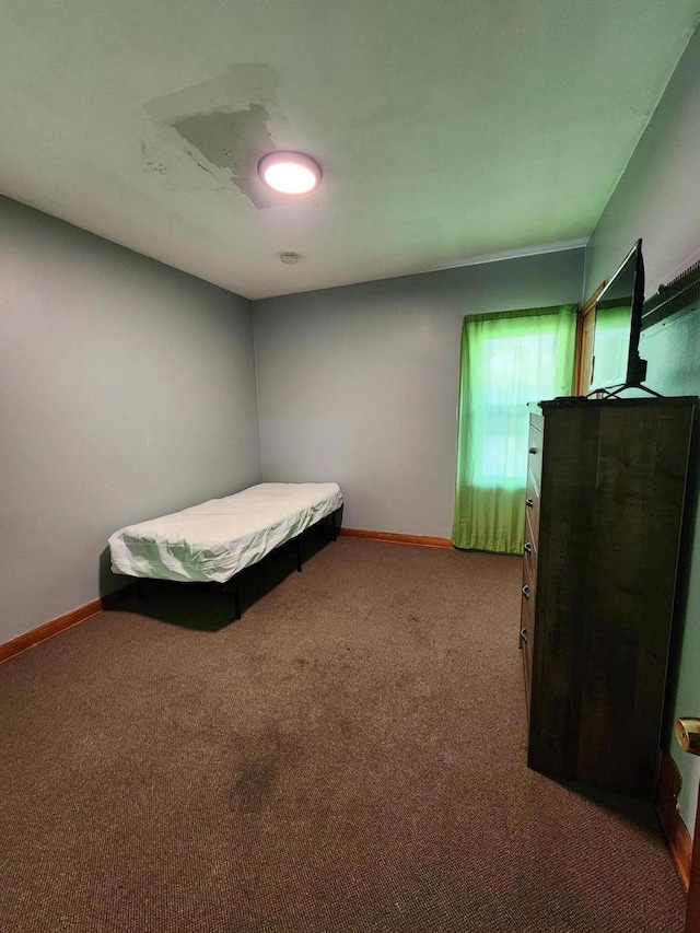 carpeted bedroom featuring baseboards