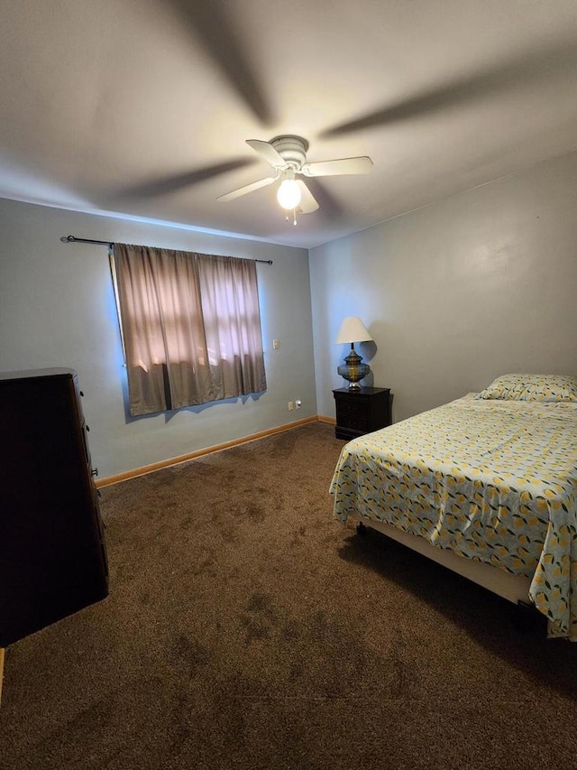 carpeted bedroom with baseboards and a ceiling fan