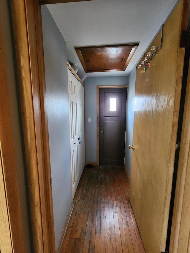 doorway to outside featuring wood-type flooring and baseboards