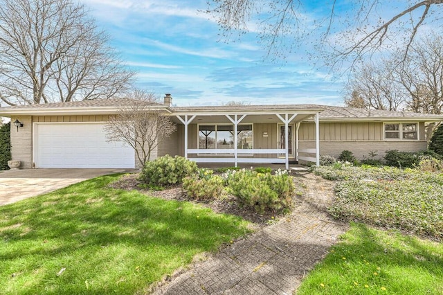 ranch-style home featuring an attached garage, brick siding, a chimney, covered porch, and driveway
