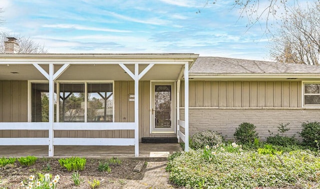 doorway to property with board and batten siding