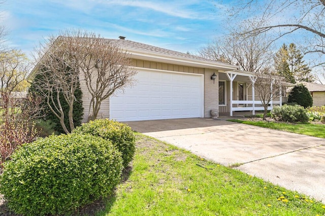 ranch-style home with concrete driveway, brick siding, and a garage