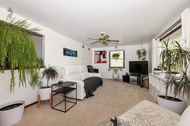 living area featuring a ceiling fan and light carpet