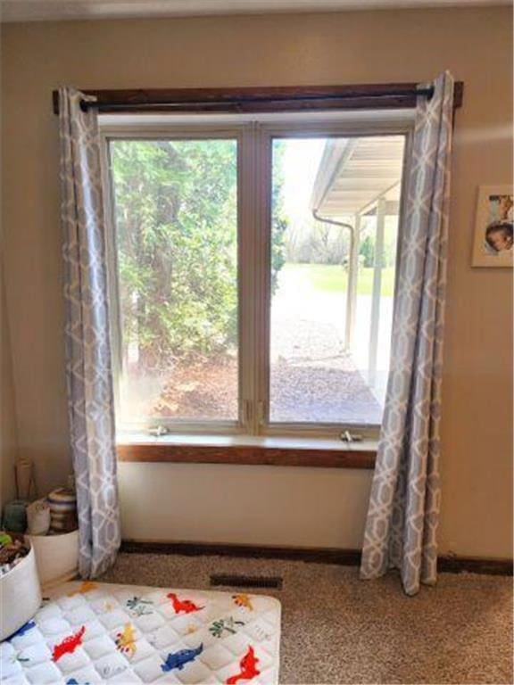 interior space featuring baseboards and visible vents