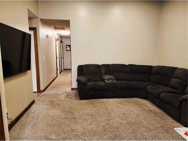 living room with baseboards and light carpet