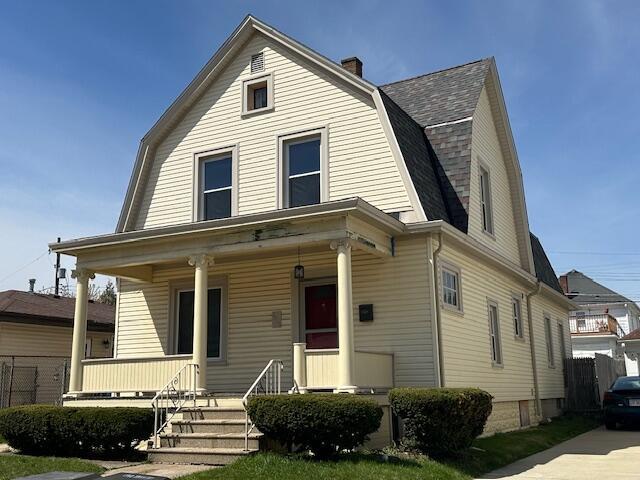dutch colonial featuring a gambrel roof, roof with shingles, covered porch, and a chimney