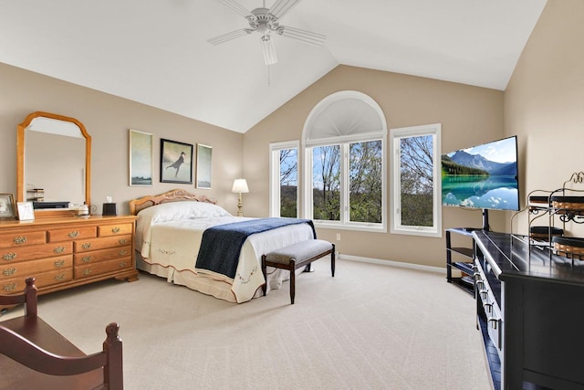 bedroom featuring light colored carpet, a ceiling fan, baseboards, and lofted ceiling
