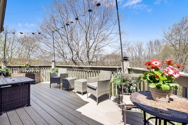 wooden deck featuring outdoor dining area