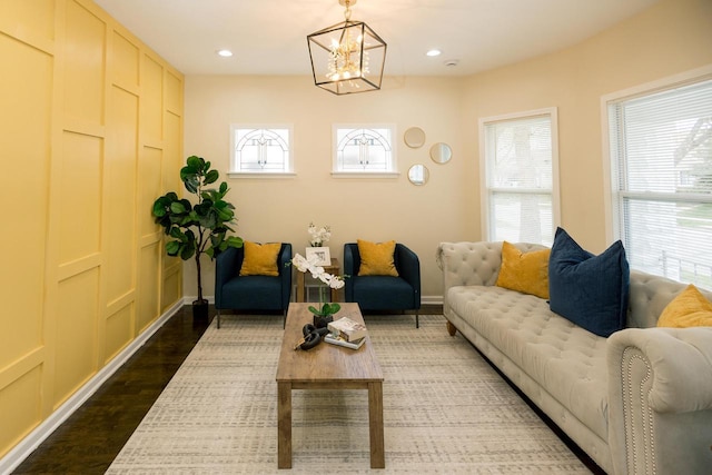 living room with dark wood-type flooring, recessed lighting, baseboards, and a notable chandelier