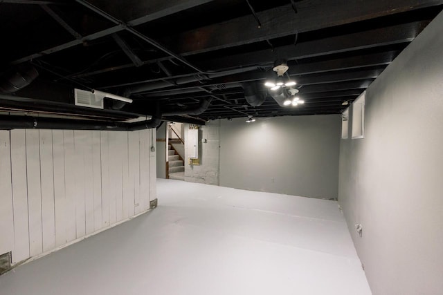 finished basement featuring stairs and visible vents