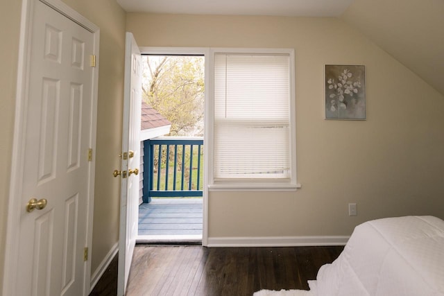 bedroom with wood-type flooring, baseboards, and lofted ceiling