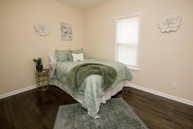bedroom featuring baseboards and wood finished floors
