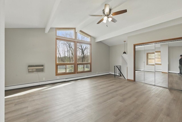 interior space featuring a healthy amount of sunlight, a baseboard radiator, an AC wall unit, and wood finished floors