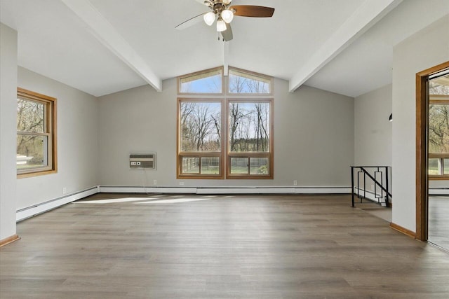 interior space featuring wood finished floors, baseboards, lofted ceiling with beams, a wall unit AC, and a ceiling fan