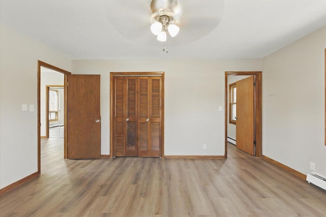 unfurnished bedroom with a ceiling fan, baseboards, baseboard heating, and light wood-style floors