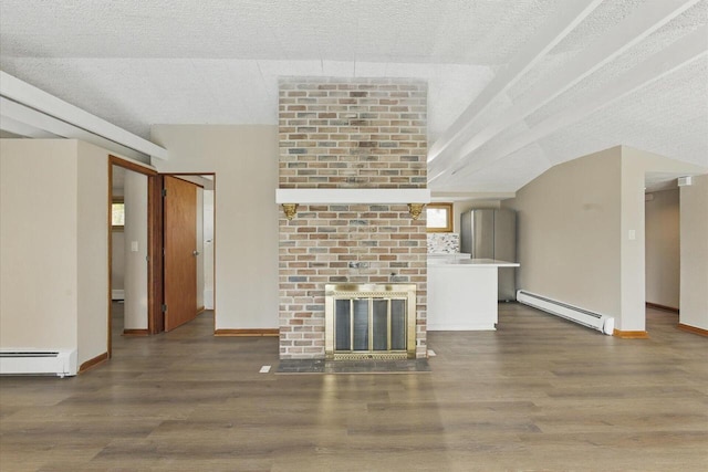 unfurnished living room featuring baseboards, a baseboard heating unit, and wood finished floors