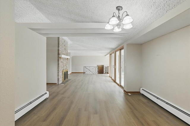 hallway with a baseboard radiator, a notable chandelier, a textured ceiling, and wood finished floors