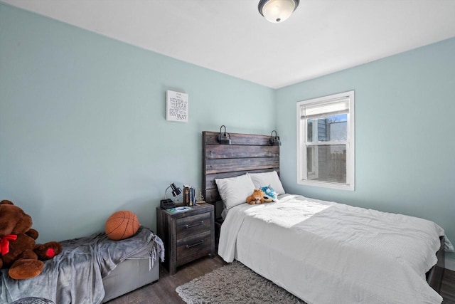 bedroom with dark wood finished floors