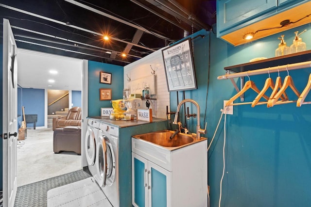 laundry area featuring washing machine and dryer, light colored carpet, cabinet space, a sink, and wet bar