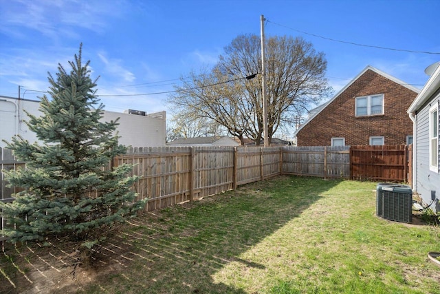 view of yard featuring a fenced backyard and central air condition unit
