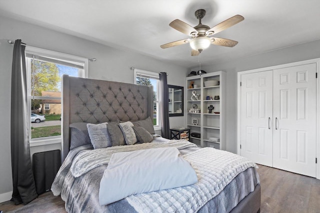 bedroom featuring a closet, a ceiling fan, and dark wood-style flooring