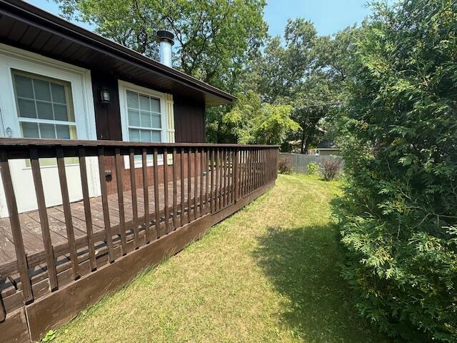 view of yard featuring fence and a deck