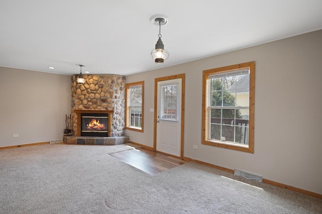 unfurnished living room with carpet floors and baseboards