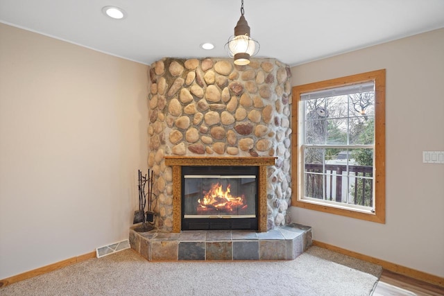interior details featuring visible vents, recessed lighting, baseboards, and a stone fireplace