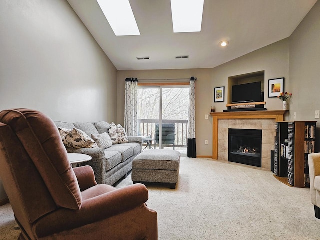 850 Evergreen Dr Unit 8, Hartford, WI 53027 - living area with a tiled fireplace, carpet, vaulted ceiling with skylight, and visible vents