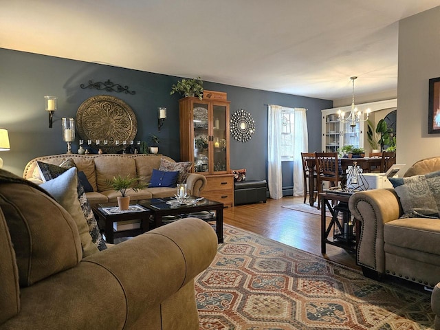 living area featuring wood finished floors and a notable chandelier