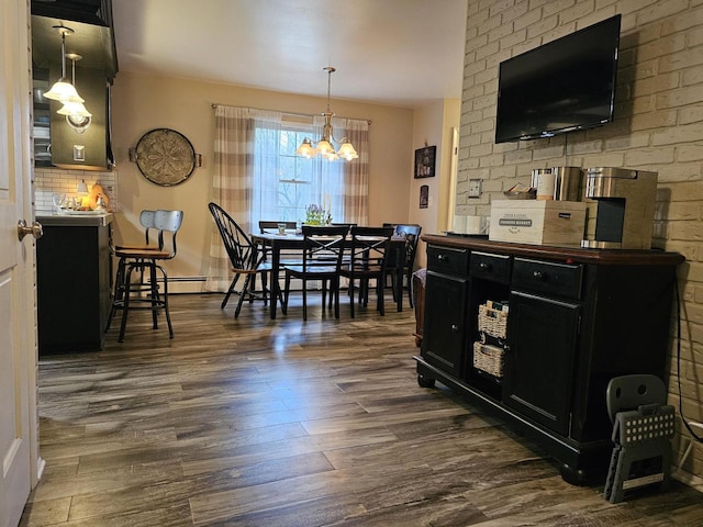 dining room featuring baseboards, dark wood-style flooring, and a chandelier